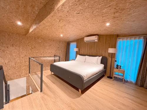 a bedroom with a bed and a staircase in it at The X10 Nordic Tent and Glamping Pool Villa Khaoyai เขาใหญ่ - SHA Certified in Ban Thung Sawang