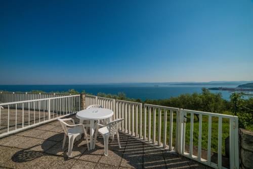 a table and chairs on a balcony with the ocean at Belvedere Resort Hotels in Izola