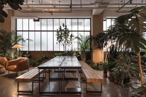 a large room with a table and some plants at SI Hotel in Taichung