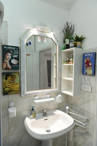 a bathroom with a white sink and a mirror at Maison Lepore in Vietri di Potenza