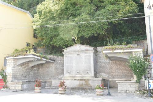 a stone wall with two doors and potted plants at Maison Lepore in Vietri di Potenza