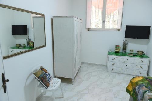 a white room with a dresser and a mirror at Maison Lepore in Vietri di Potenza