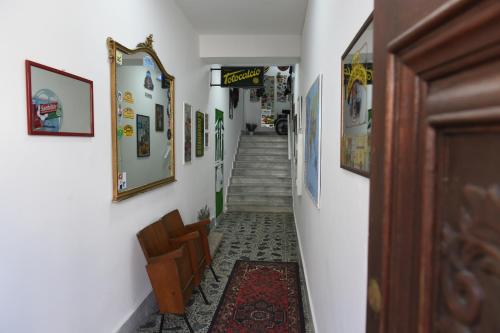 a hallway with a stairway with pictures on the walls at Maison Lepore in Vietri di Potenza