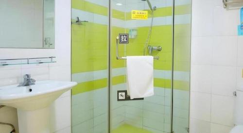 a bathroom with a sink and a shower with a sink at 7 Days Inn Guangrao Bus Station in Dongying