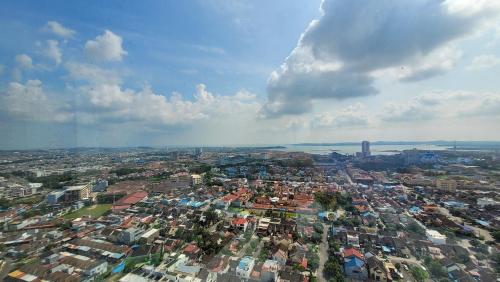 an aerial view of a city with buildings at Palam Mansion at Meisterstadt Pollux Habibie Apartment in Batam Center
