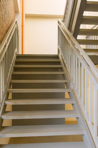a stairwell in a building with a stair case at Vailoa Studio, 2 Beds, AC, Wi-fi, TV, 5min to town in Vaitele