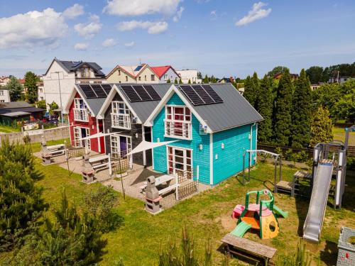 a house with solar panels on it with a playground at Domki Primore in Władysławowo