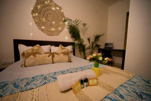 a bedroom with a bed with a chandelier at 3Bhk Villa with Swimming Pool I Nyra Homestay in Jaipur