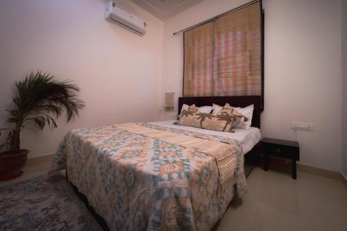a bedroom with a bed in a room with a window at 3Bhk Villa with Swimming Pool I Nyra Homestay in Jaipur