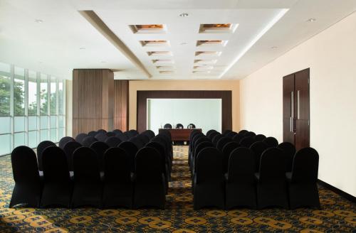 a conference room with black chairs and a table at Best Western Premier La Grande Bandung in Bandung