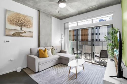 a living room with a couch and a table at Centric 2BR In HEART of DTPHX Free Garage Parking in Phoenix
