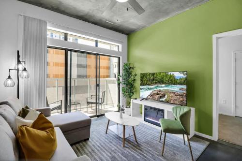 a living room with a couch and a tv at Centric 2BR In HEART of DTPHX Free Garage Parking in Phoenix
