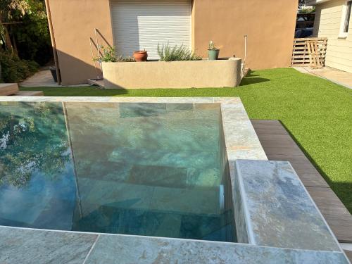 a swimming pool in a yard next to a house at chambre suite B&B in Montpellier