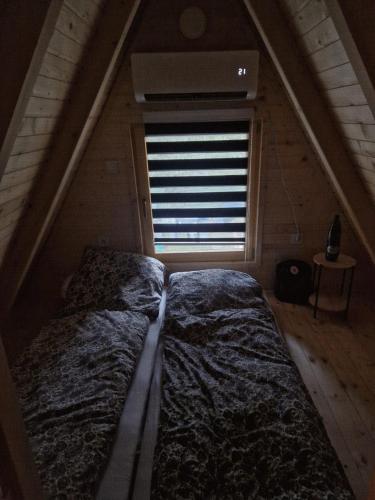 a bedroom with two beds and a window at Fikro's Resort in Kulen Vakuf