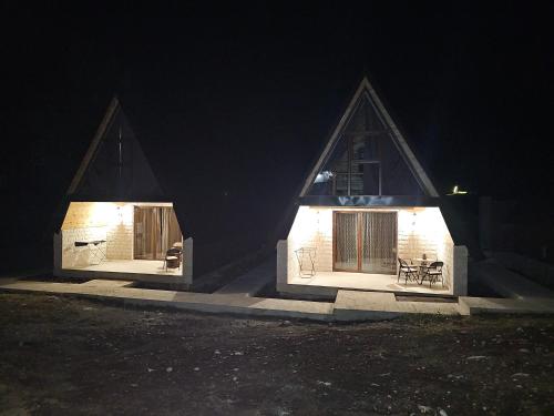 a house with lights on the side of it at night at Moj raj Zabljak in Borje