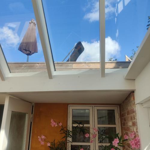 an internal view of the roof of a house with an umbrella at Eget anneks på landet, tæt på skov og strand in Græsted