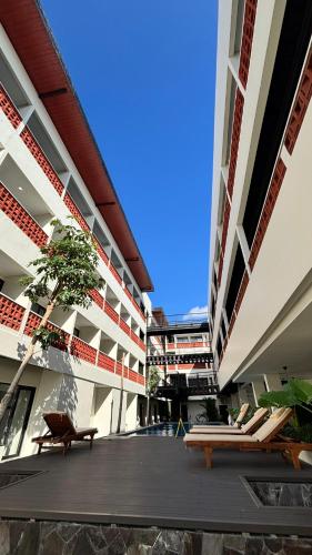 a view of a building with benches in the courtyard at Alzeto Coliving in Legian