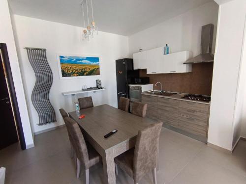 a kitchen and dining room with a table and chairs at Villa Nunzia in Ostuni
