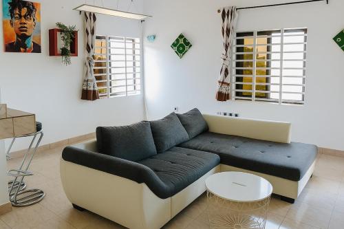 a living room with a couch and a table at Cozy apartment in Calavi-Akassato - V2 in Abomey-Calavi