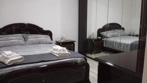 a bedroom with a bed and a mirror at Casa Relax - Relax Holiday in Valledolmo