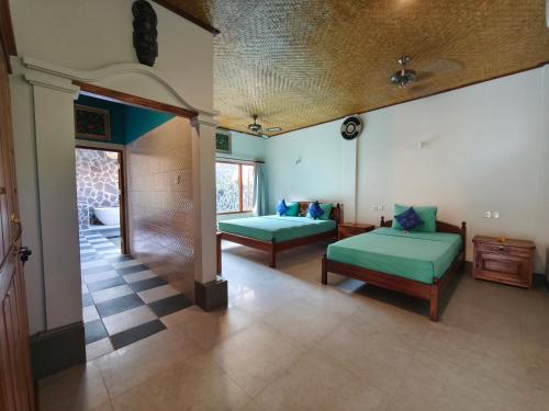 a living room with two beds and a room with at 1000 Dream Bungalow in Lovina
