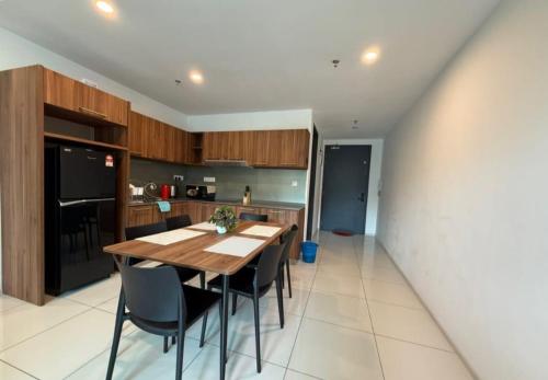 a kitchen and dining room with a table and chairs at Sunway Onsen Theme Park View Ipoh in Ipoh