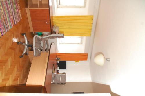 a bathroom with a sink and wooden cabinets at Stanjel Carst House 13 Andreja in Štanjel