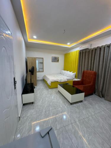 a hotel room with a bed and a couch at Utako Studio Apartments-City Center in Abuja