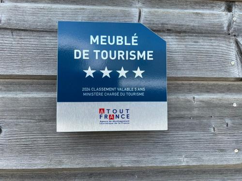 a sign on a wooden wall that reads vehicle de touphrine at Beach House in Port-Bail-sur-Mer