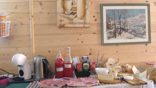 a kitchen counter with a table with food and drinks at Villa Amaranta Room and Breakfast in Edolo