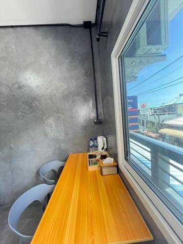 a wooden table in a room with a window at K2N Guesthouse in Koh Tao