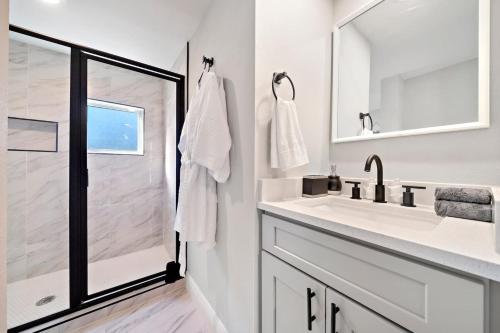 a white bathroom with a sink and a shower at Med Center Studio Near Museums Fire Pit WiFi BBQ in Houston