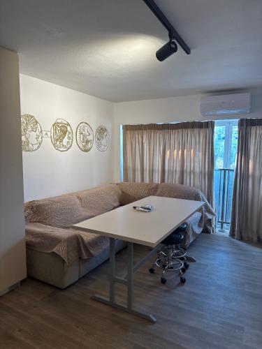 a room with a bed and a table in it at BLUE LINE Coliving in Piraeus