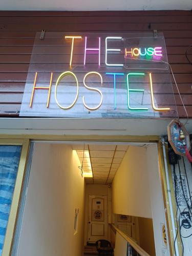a neon sign on the front of a house at The House Hostel 2 in Bangkok