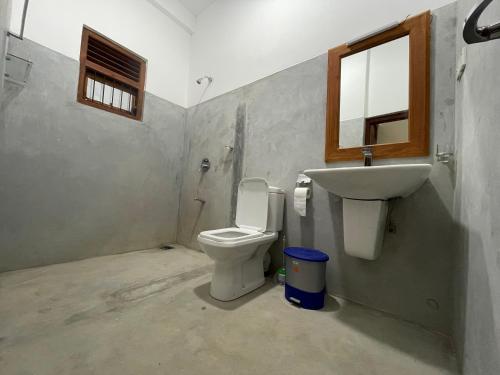 a bathroom with a toilet and a sink at Lucky 's place unawatuna in Unawatuna