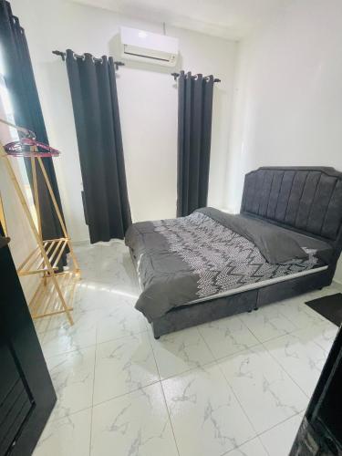 a bedroom with a bed with black drapes at D Aur Poolvilla Seaview in Bachok