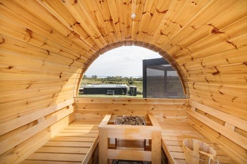 an interior view of a wooden sauna with a window at PALO Borbirtok - Bed and Wine in Paloznak