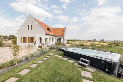 a house with a pool in the yard at PALO Borbirtok - Bed and Wine in Paloznak
