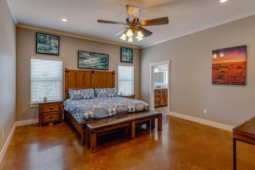 a bedroom with a bed and a ceiling fan at Retreat Abilene A Retreat Dfw Experience in Ovalo