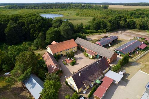 an overhead view of a school building with trees and a lake at Land Gut Berlinchen in Berlinchen