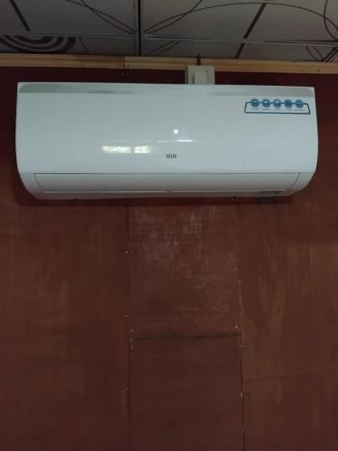 a white appliance sitting on top of a wooden table at Sigiri Panaromic Tree House in Sigiriya