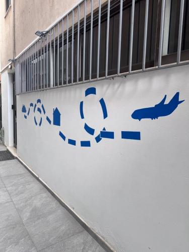 a sign on a wall with arrows on it at BLUE LINE Coliving in Piraeus