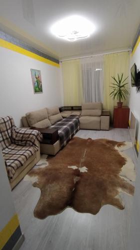 a living room with a couch and a living room with a table at Devolano 1 in Odesa