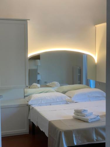 a bedroom with two beds with towels on them at B&B Madreperla in Gallipoli
