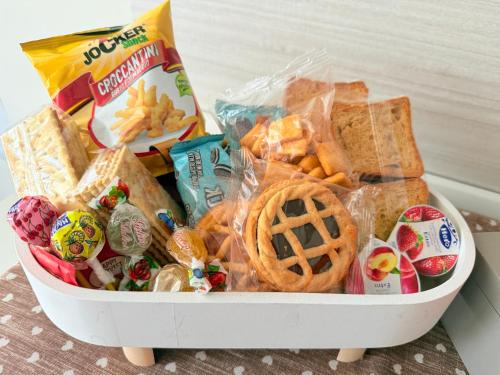 a basket filled with snacks and crackers and cookies at Deny & Carol's house in Somma Lombardo
