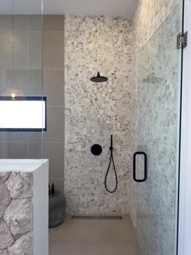 a bathroom with a shower with a shower at Julim Aura - Best Agung View in Amed