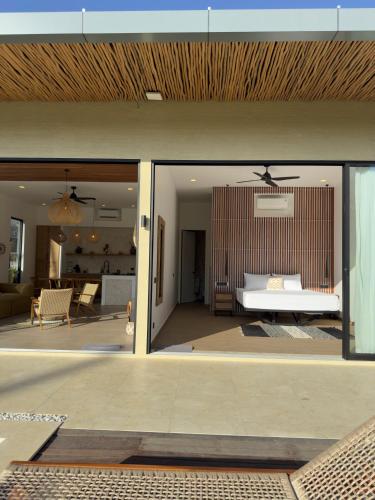 a bedroom with a bed and a living room at Julim Aura - Best Agung View in Amed