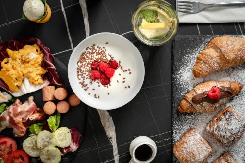 a table topped with a plate of food with strawberries at Hotel Grazia Riccione in Riccione