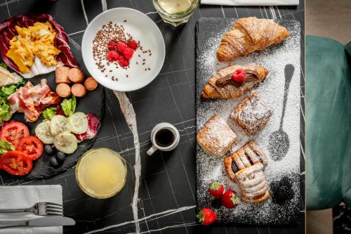 a table topped with plates of food and drinks at Hotel Grazia Riccione in Riccione