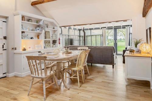 a kitchen and dining room with a table and chairs at The Lodge at Greenbank Farm 